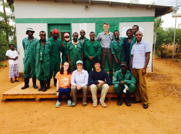 Students and Rwandan locals pose for a photo