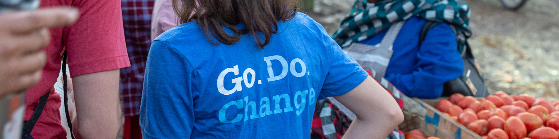 Person wearing a blue shirt that says Go. Do. Change. 
