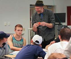 Aaron Knochel, assistant professor of art education, talks to students during a session of Making for the Masses. 