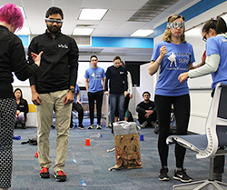 Britelab and Leadership & Innovation Lab members make their way through an obstacle course during the 2018 Design Olympics. Lab members were blindfolded and led through the obstacle course by a partner.