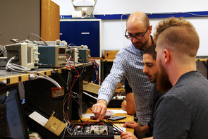Joseph Cuiffi, program coordinator and assistant teaching professor of electro-mechanical engineering technology at Penn State New Kensington, works with student
