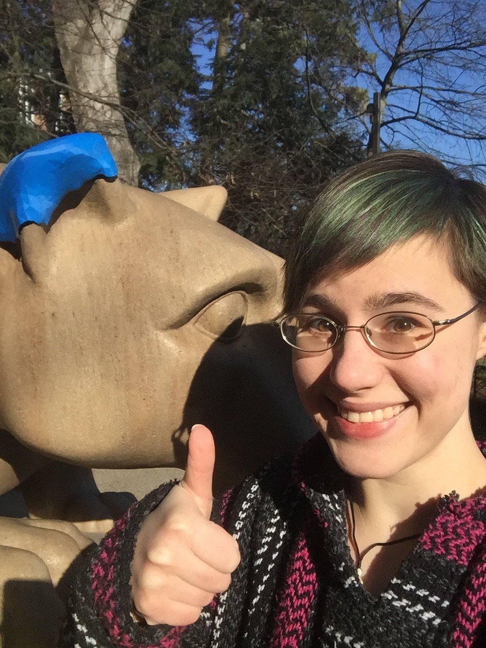 Anne Pauley with the 3D-printed replacement ear for the Lion Shrine.
