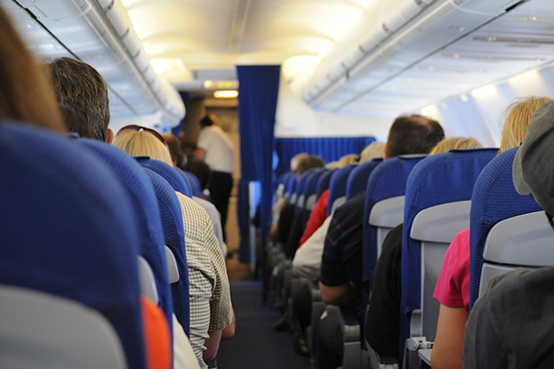 Passengers sitting in airplane seats