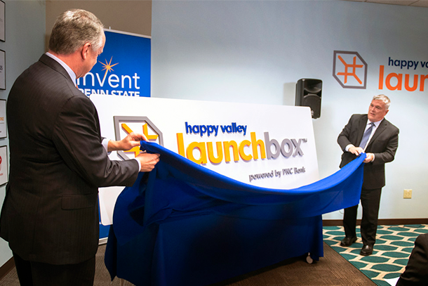 Jim Hoehn, regional president of PNC Bank, with Penn State President Eric Barron, unveiled the new "Happy Valley Launchbox-Powered by PNC Bank" logo